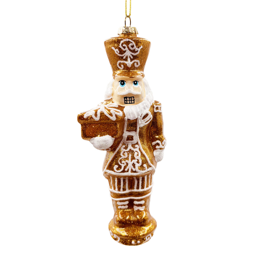 Gold and White Nutcracker Ornament Holding a Gift