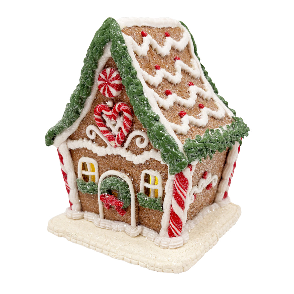 Lit Gingerbread House with Pine Frosting Garland