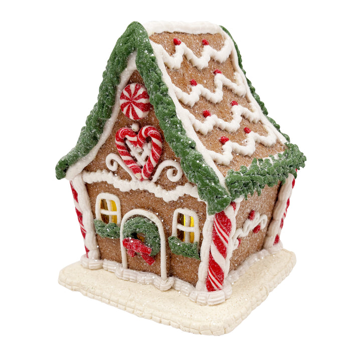 Lit Gingerbread House with Pine Frosting Garland